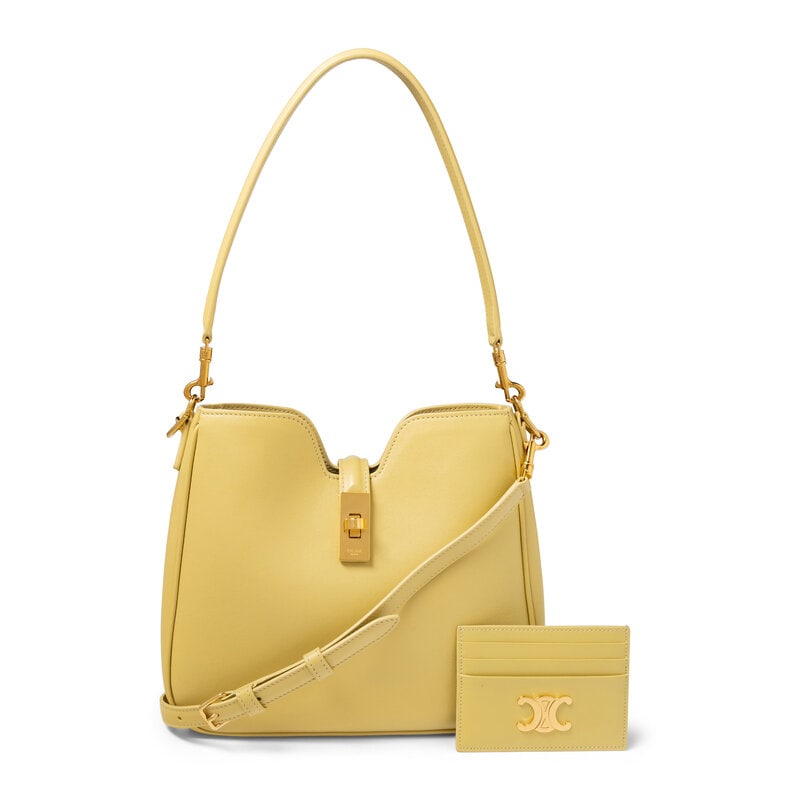 CELINE, CAMILLE 16 BAG & CARDHOLDER: CELINE, CAMILLE 16 BAG & CARDHOLDER THE FIRST Small Camille 16 bag in pale yellow smooth calfskin leather. Turn-lock clasp closure, removable flat leather handle and removable flat leather