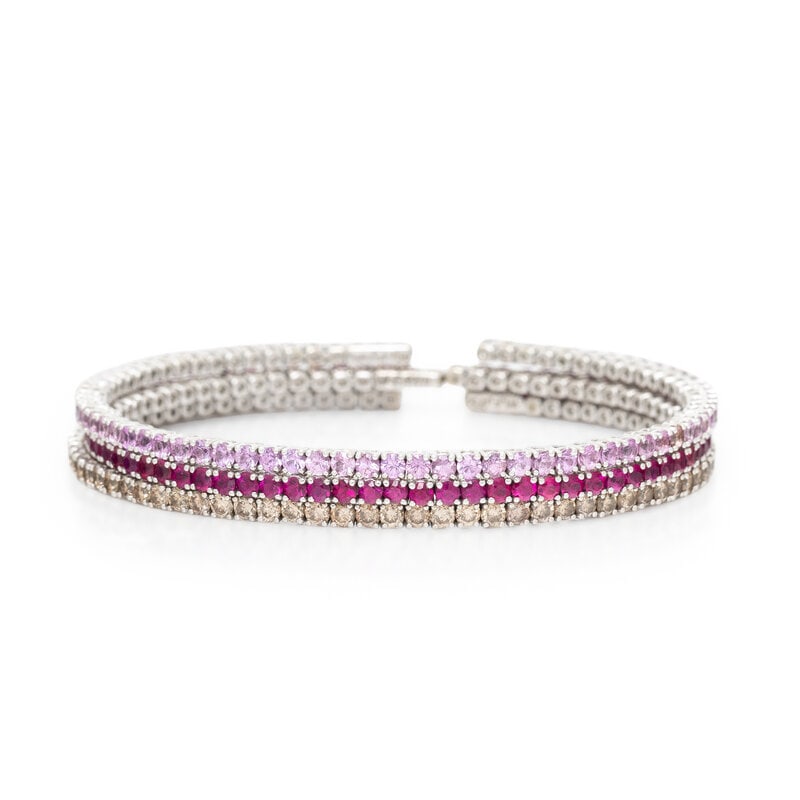 SET OF WHITE GOLD AND GEMSTONE FLEXIBLE STACKING CUFF BRACELETS: SET OF WHITE GOLD AND GEMSTONE FLEXIBLE STACKING CUFF BRACELETS One set with round rubies, one set with round pink sapphires, and one set with round brown diamonds (origin of color not tested)