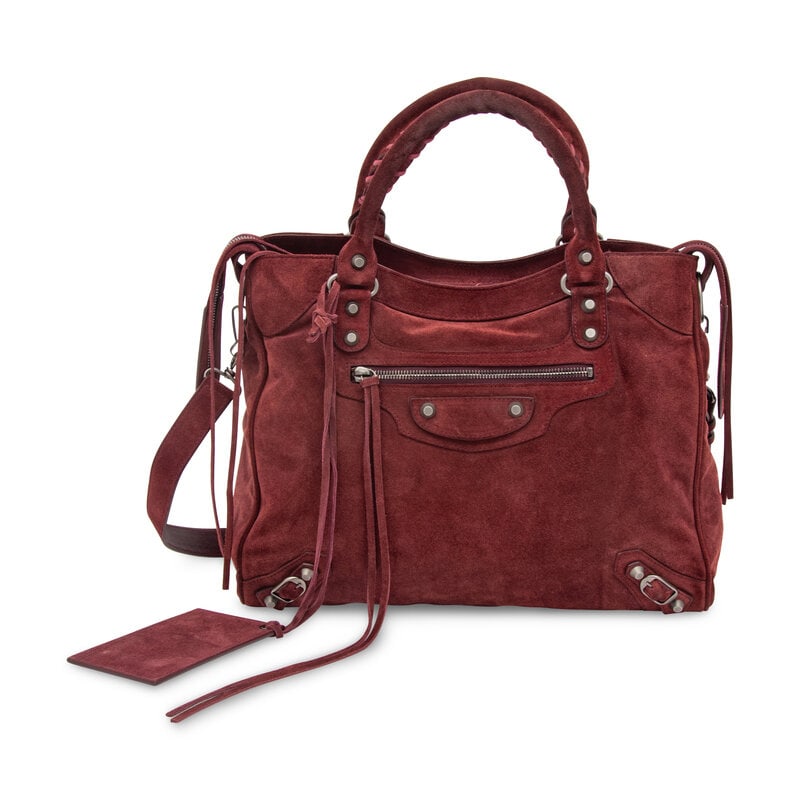 BALENCIAGA, BURGUNDY SUEDE CITY BAG: BALENCIAGA, BURGUNDY SUEDE CITY BAG Medium City Bag in burgundy suede. Double zipper closure, rolled suede handles with whipstitching, and removable flat suede shoulder strap. Label: Balenciaga