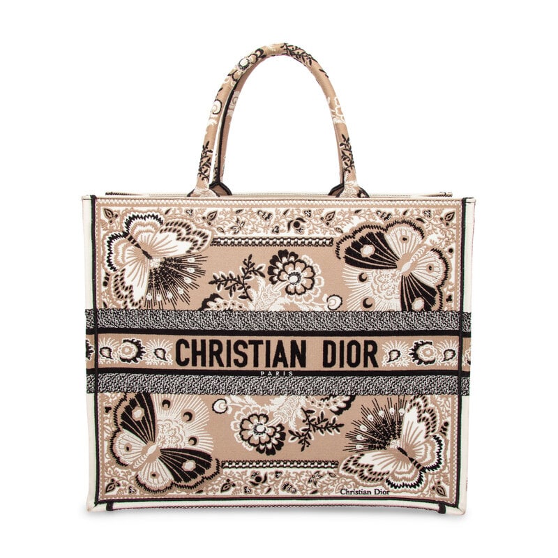 CHRISTIAN DIOR, LARGE BUTTERFLY BOOK TOTE: CHRISTIAN DIOR, LARGE BUTTERFLY BOOK TOTE Large Book Tote bag in black and tan butterfly & floral-embroidered white canvas. Rolled top handles. Label: Christian Dior Style/Serial No.: 50-MA-0293