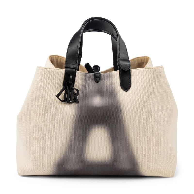 CHRISTIAN DIOR, EIFFEL TOWER TOUJOURS TOTE: CHRISTIAN DIOR, EIFFEL TOWER TOUJOURS TOTE Toujours Tote bag in beige canvas with a blurred Eiffel Tower print on one side. Turn-lock clasp closure and flat leather straps. Label: Christian Dior