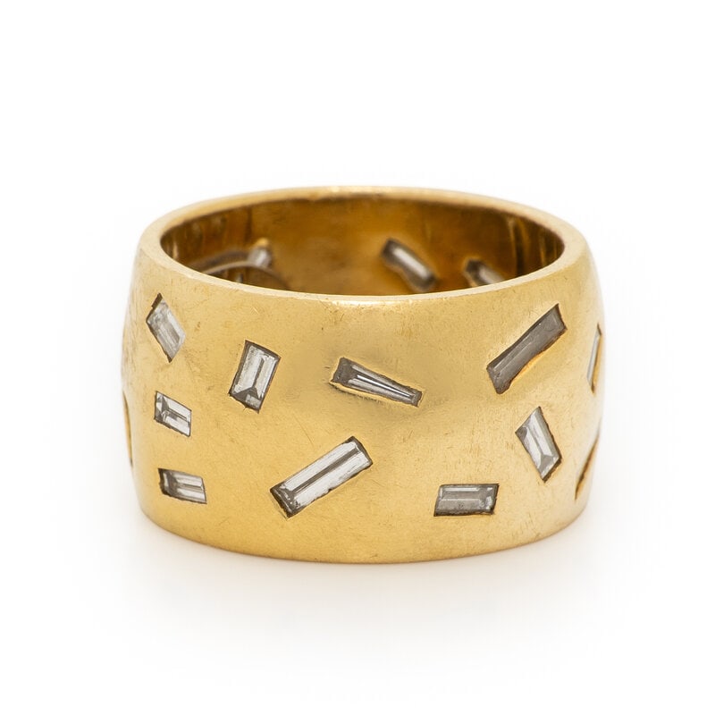 YELLOW GOLD AND DIAMOND BAND: YELLOW GOLD AND DIAMOND BAND Baguette cut diamonds weighing approximately 1.80 carats total. Yellow gold. Ring size 4 1/2. Gross weight: 9.05 dwt. ConditionOverall Condition: Moderate scratches and