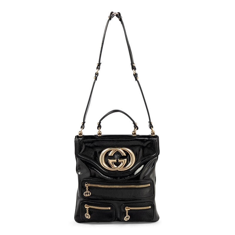 GUCCI, BLACK PATENT BRITT TOTE BAG: GUCCI, BLACK PATENT BRITT TOTE BAG Britt Tote bag in black patent leather. Snap closure, flat leather handle, and flat leather shoulder strap. Label: Gucci Style/Serial No.: 167723-486628 Date: