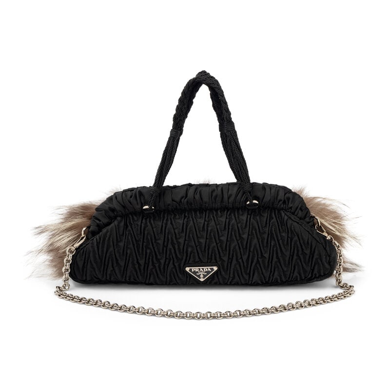 PRADA, FOX FUR & NYLON HANDBAG: PRADA, FOX FUR & NYLON HANDBAG Handbag in black quilted nylon and dyed fox fur. Magnetic snap closures, braided handles, and removable chain shoulder strap. Label: Prada Style/Serial No.: