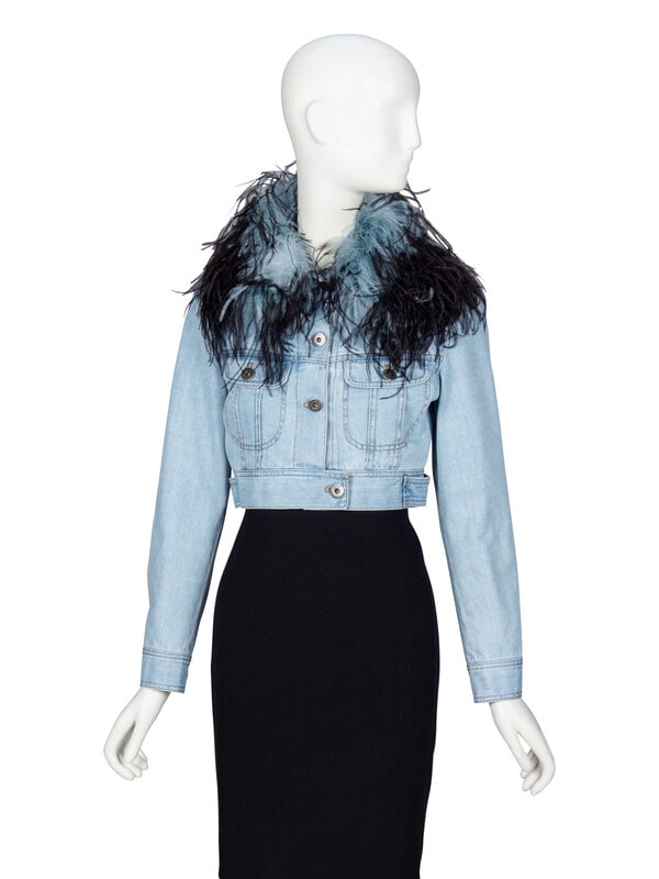 PRADA, FEATHER COLLAR CROP DENIM JACKET: PRADA, FEATHER COLLAR CROP DENIM JACKET Cropped jacket in light wash cotton denim. Features a black & light blue-dyed ostrich feather removable collar; removable via interior snaps. Spread collar.