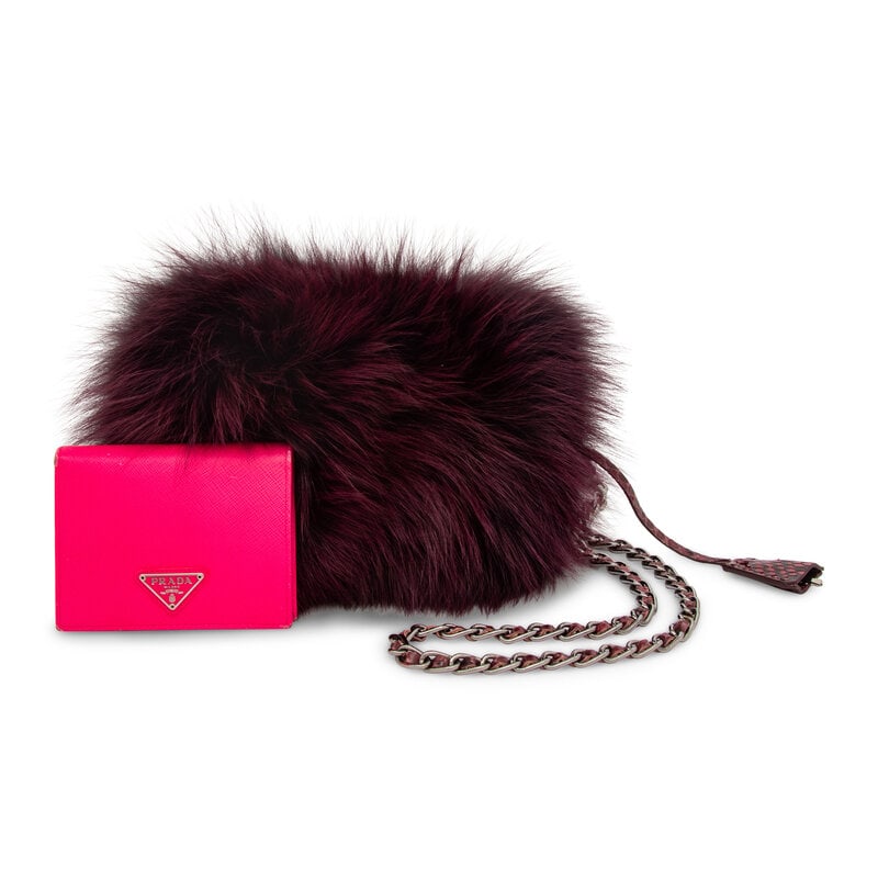 PRADA, PURPLE FOX FUR BAG & PINK WALLET: PRADA, PURPLE FOX FUR BAG & PINK WALLET THE FIRST Clutch/shoulder bag in purple-dyed blue fox fur with purple snakeskin trim. Zipper closure and removable interwoven snakeskin-metal chain