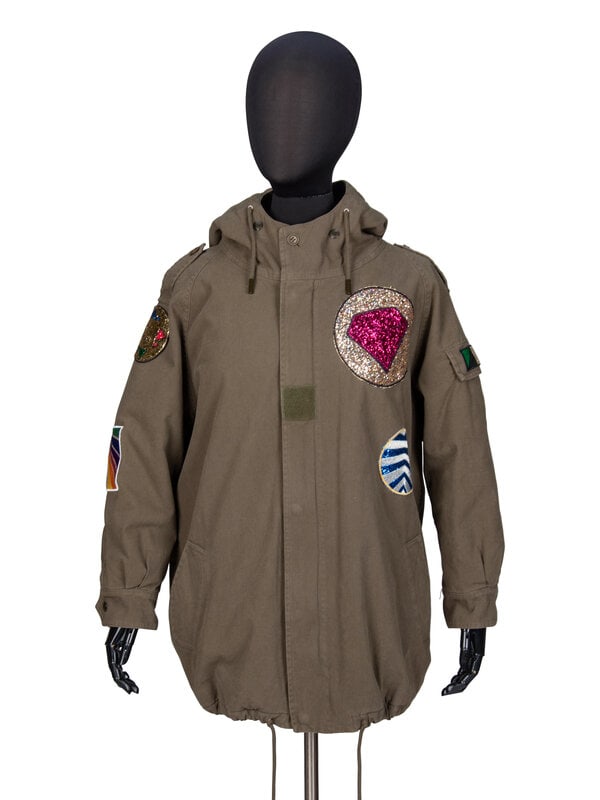 SAINT LAURENT, HOODED PARKA WITH PATCHES: SAINT LAURENT, HOODED PARKA WITH PATCHES Hip-length parka jacket in green cotton twill with multicolor glittered & embroidered patches throughout. Attached hood with drawstrings and button