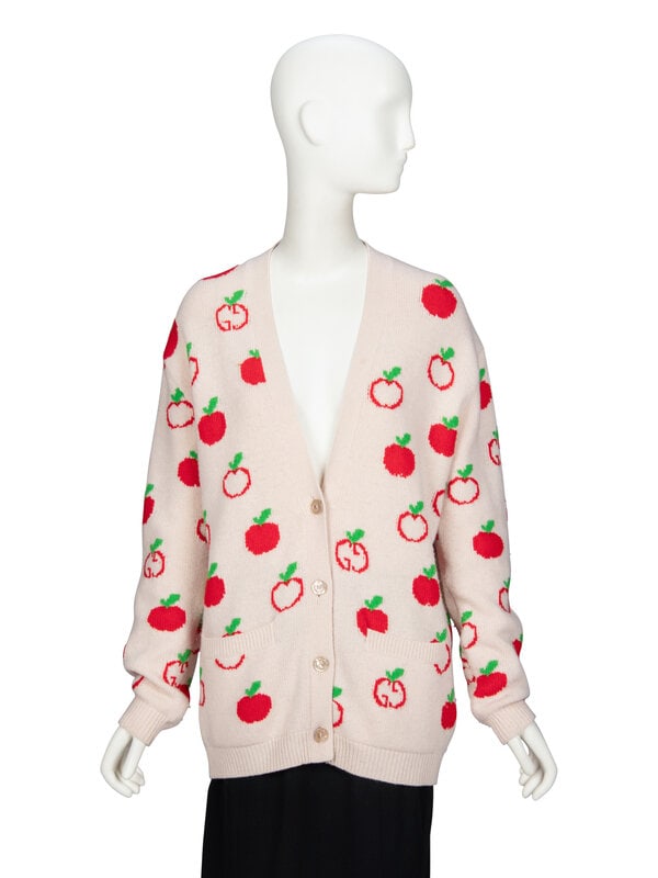 GUCCI, APPLE KNIT WOOL CARDIGAN: GUCCI, APPLE KNIT WOOL CARDIGAN Long oversized cardigan in beige and apple-motif intarsia-knit wool. V neckline. Dropped shoulder seams. Full-length sleeves with ribbed knit trim at hems. Two welt