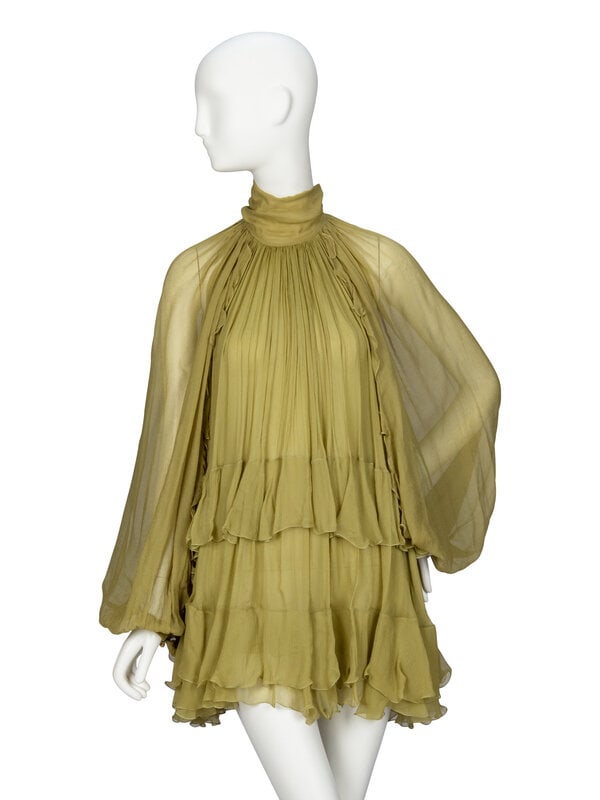 CHLOÉ, GREEN RUFFLE MINIDRESS: CHLOÉ, GREEN RUFFLE MINIDRESS Long sleeve minidress/blouse in avocado green silk crepon. Stand collar with extended ties at back neck. Full-length open raglan sleeves; with gathers at shoulder