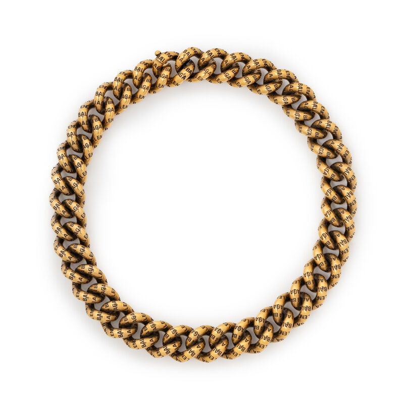 BALENCIAGA, OVERSIZE LOGO CHAIN NECKLACE: BALENCIAGA, OVERSIZE LOGO CHAIN NECKLACE Oversized cuban chain necklace in gold-tone metal with logo stamps throughout. Lifting clasp closure. Stamped "Balenciaga / Made in Italy" near opening. 