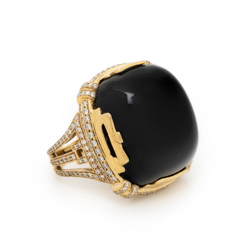 GOSHWARA, YELLOW GOLD, ONYX AND DIAMOND RING: GOSHWARA, YELLOW GOLD, ONYX AND DIAMOND RING Cushion cabochon cut black onyx measuring approximately 22.55 x 20.70 x 9.40 mm and round diamonds weighing approximately 0.90 carat total. 18 karat