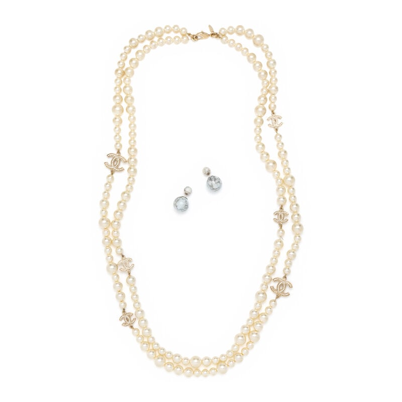 CHANEL & DIOR, NECKLACE & EARRINGS: CHANEL & DIOR, NECKLACE & EARRINGS THE FIRST Double-layered necklace in simulated pearls with rhinestone-embellished CC charms. Lobster clasp closure. Stamped "Chanel / Made in France" at