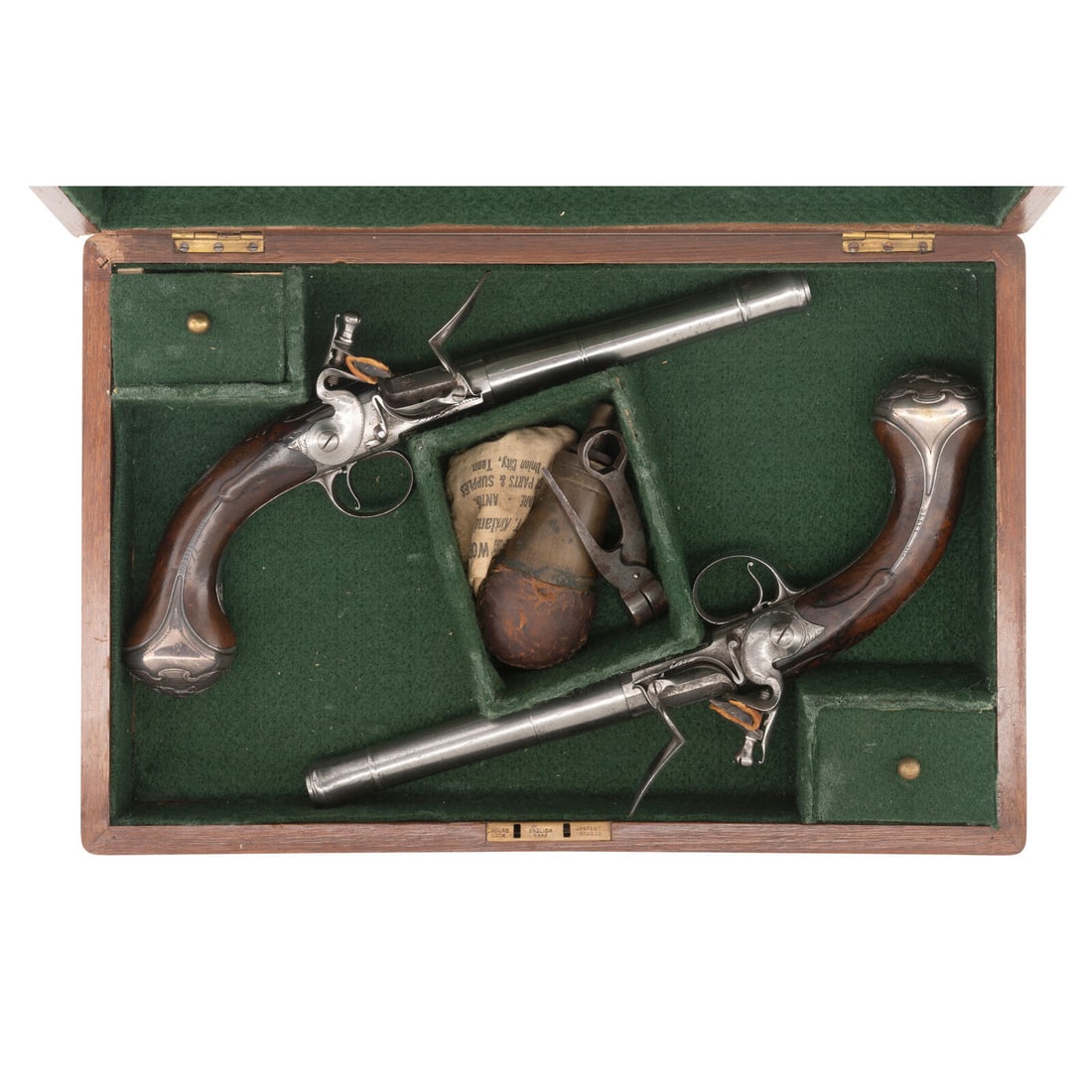 Pair of Queen Anne Flintlock Pistols by Freeman in Reconfigured Modern Case: Pair of Queen Anne Flintlock Pistols by Freeman in Reconfigured Modern Case .60 caliber. 5.5" round cannon muzzle twist-off barrels. NSN. Bright finish, iron furniture, silver plated floral pattern br