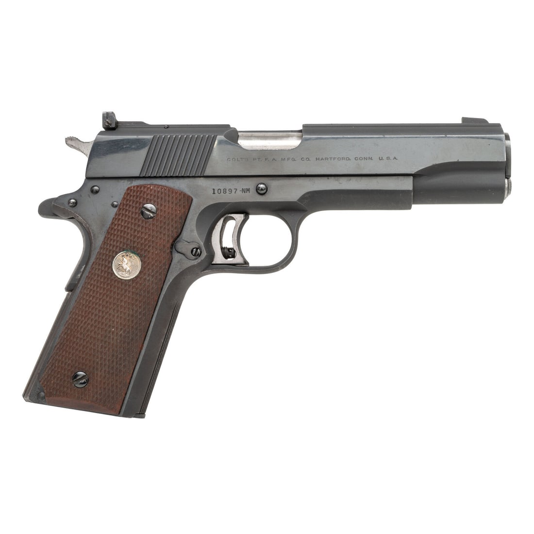 **Colt Gold Cup National Match .45: **Colt Gold Cup National Match .45 .45 ACP. 5" barrel length. SN: 10897-NM. (Mfg. Ca 1962) Blued finish with polished flats and matte rounds featuring polished barrel and checkered walnut Colt medalli