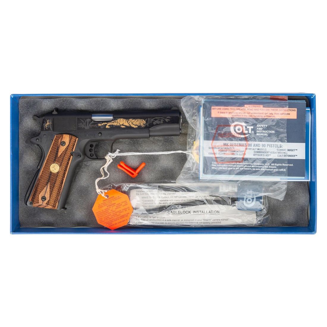 *Colt Tiger 1991A1 Pistol Commemorative in Box: *Colt Tiger 1991A1 Pistol Commemorative in Box .45 ACP. 5" barrel length. SN: 2816696. Polished blued flats and matte blued rounds mounting diamond checkered Colt medallion Cocobolo grips. Single acti