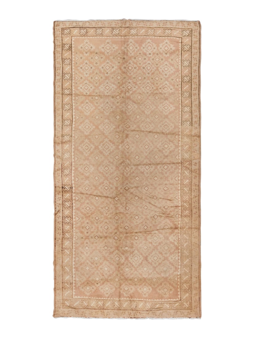 A Khotan Corridor Rug: A Khotan Corridor Rug Early 20th Century 12 feet 4 inches x 6 feet 3 inches. Property from a Private Family Trust This lot is located in Chicago.