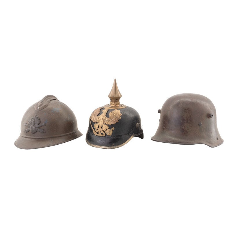 Lot of Three WWI Helmets: Lot of Three WWI Helmets 1.) M1916 Stahlhelm with WWII Liner. 7 X 9.25 X 12". Interior left helmet struck B.F.64. Item mounts both the horns for installing a brow plate, and the riveted chinstrap