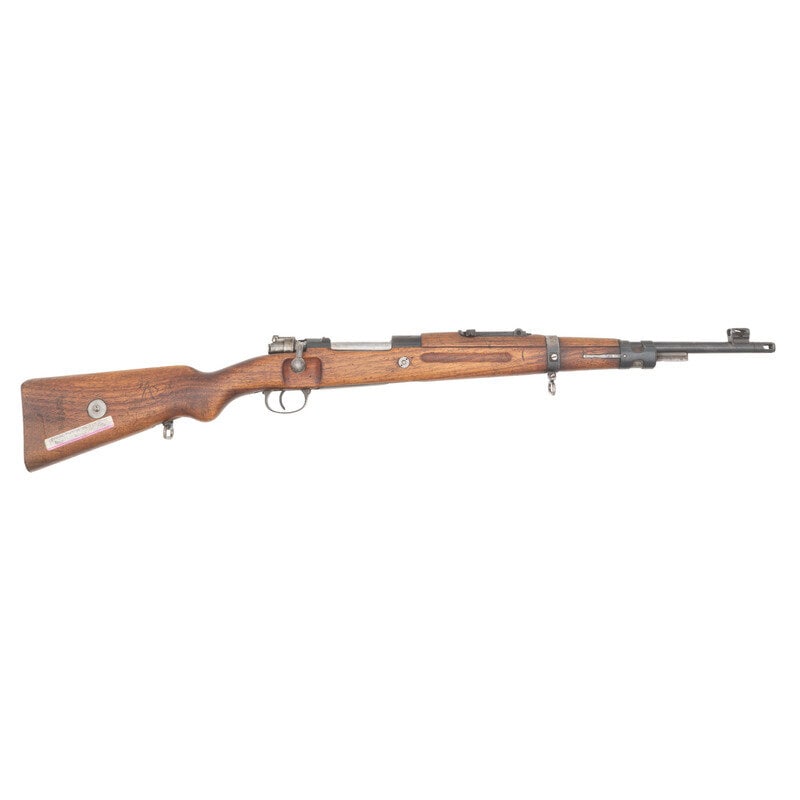 **Iranian M49 Mauser Rifle: **Iranian M49 Mauser Rifle 7.92x57mm. 18.5" barrel length. SN: 27711. Blued metal finish with polished bolt and bolt handle mounting wood semi pistol grip stock with full length upper handguard. Bolt