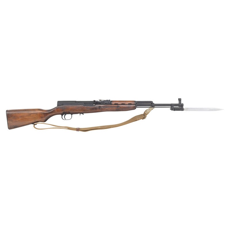 **Tula SKS Rifle with Missing Magazine: **Tula SKS Rifle with Missing Magazine 7.62x39. 20" barrel length. SN: RH028037. Blued metal finish set in laminated wood semi pistol grip stock with upper handguard. Short stroke piston gas