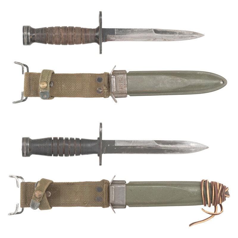 Two US M4 Bayonets with Scabbard: Two US M4 Bayonets with Scabbard World War II 1) US M4 Bayonet by Camillus. 6.5" Parkerized blade, 11.25" overall. Leather washer grip with 6 grooves and Bakelite spacers at the ends. Includes a US