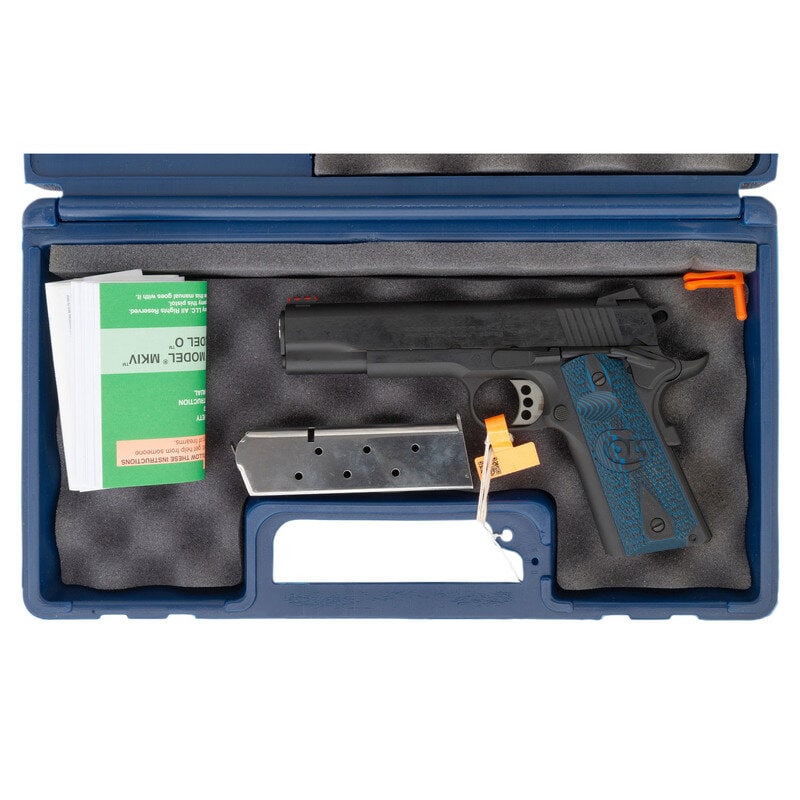 *Colt 1911 Competition Series: *Colt 1911 Competition Series .45 ACP. 5" barrel length. SN: CCS033288. Blued metal finish and stainless barrel with synthetic blue G10 checkered grip panels mounting Novak rear sight and fiber optic