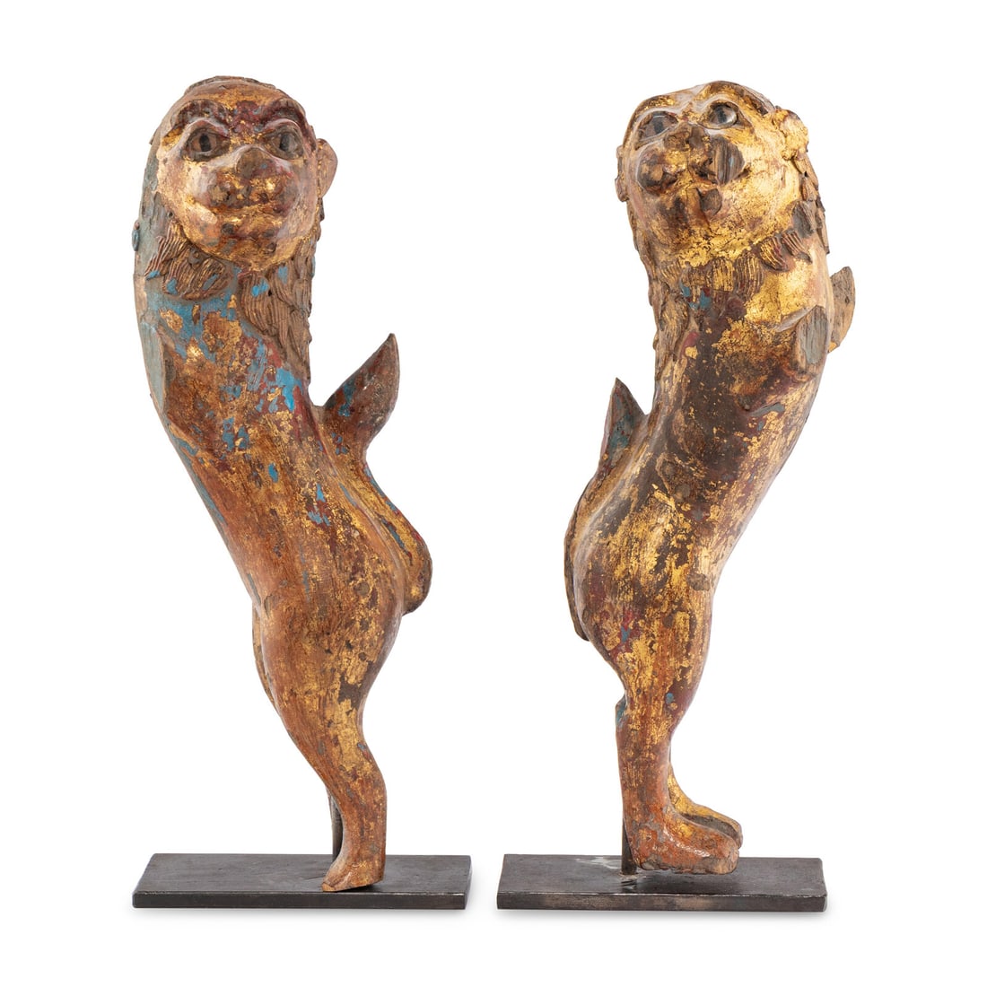 A Pair of Parcel-Gilt and Polychrome Decorated Lion-Form Crest Supporters: A Pair of Parcel-Gilt and Polychrome Decorated Lion-Form Crest Supporters 18th/19th Century each mounted on a modern metal stand. Height overall of taller example 18 1/2 inches. This lot is located in