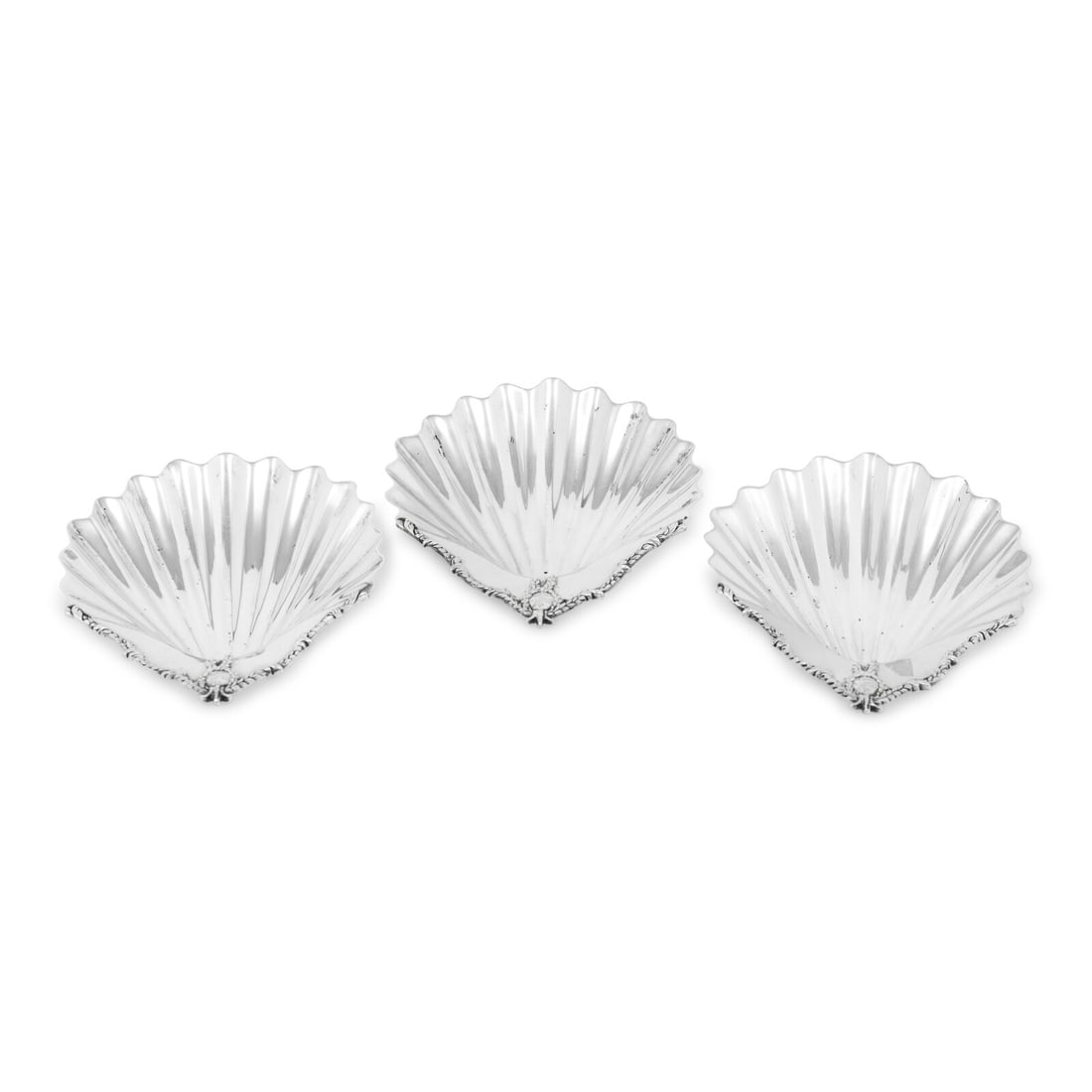 A Set of Three George III Silver Scallop-Form Dishes: A Set of Three George III Silver Scallop-Form Dishes Henry Greenway and Charles Aldridge, London, 1775 each decorated with a laurel bordered cartouche engraved with a crest of a griffin rampant holdin