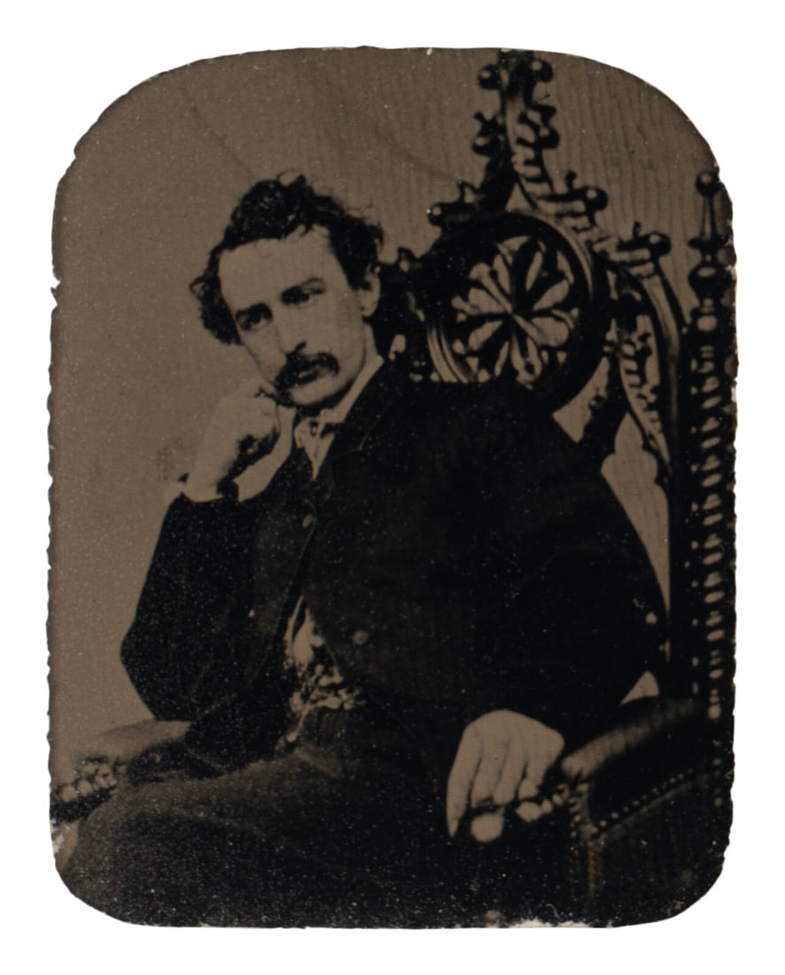 [BOOTH, John Wilkes (1838-1865)]. Tintype depicting a seated John Wilkes Booth, ca 1864. (1 of 3)