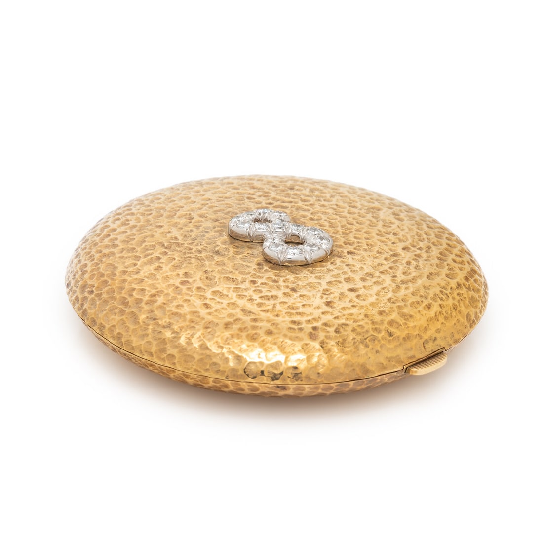 FRENCH, YELLOW GOLD AND DIAMOND COMPACT: FRENCH, YELLOW GOLD AND DIAMOND COMPACT Designed as a hammered gold compact with the number 8 set with round diamonds weighing approximately 1.05 carats total, a mirrored interior, pressed powder, and