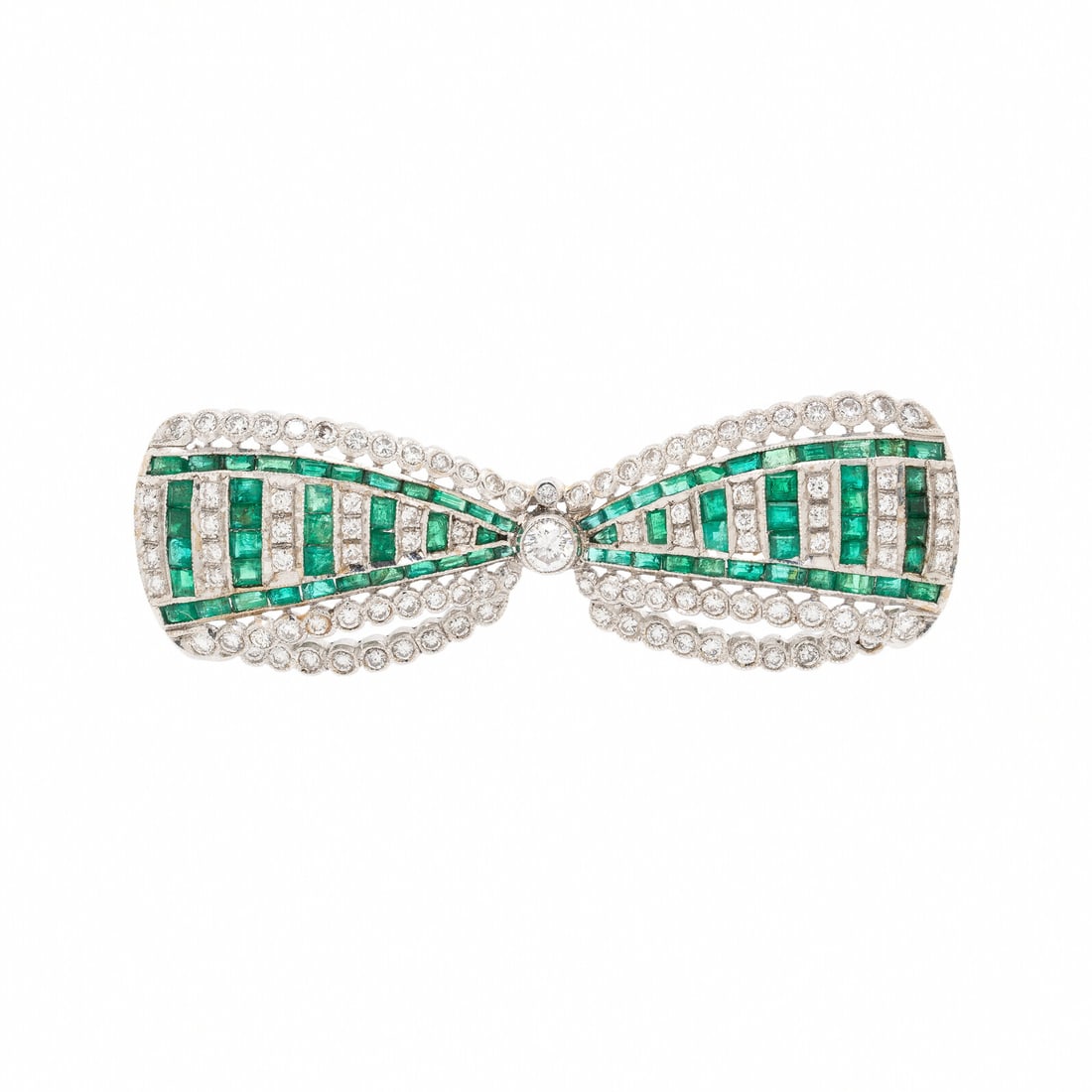 EMERALD, DIAMOND, AND WHITE GOLD BOW BROOCH: EMERALD, DIAMOND, AND WHITE GOLD BOW BROOCH In a bow design, set with round and transitional cut diamonds weighing approximately 0.95 carat total and calibré cut emeralds. Mounted in 18 karat