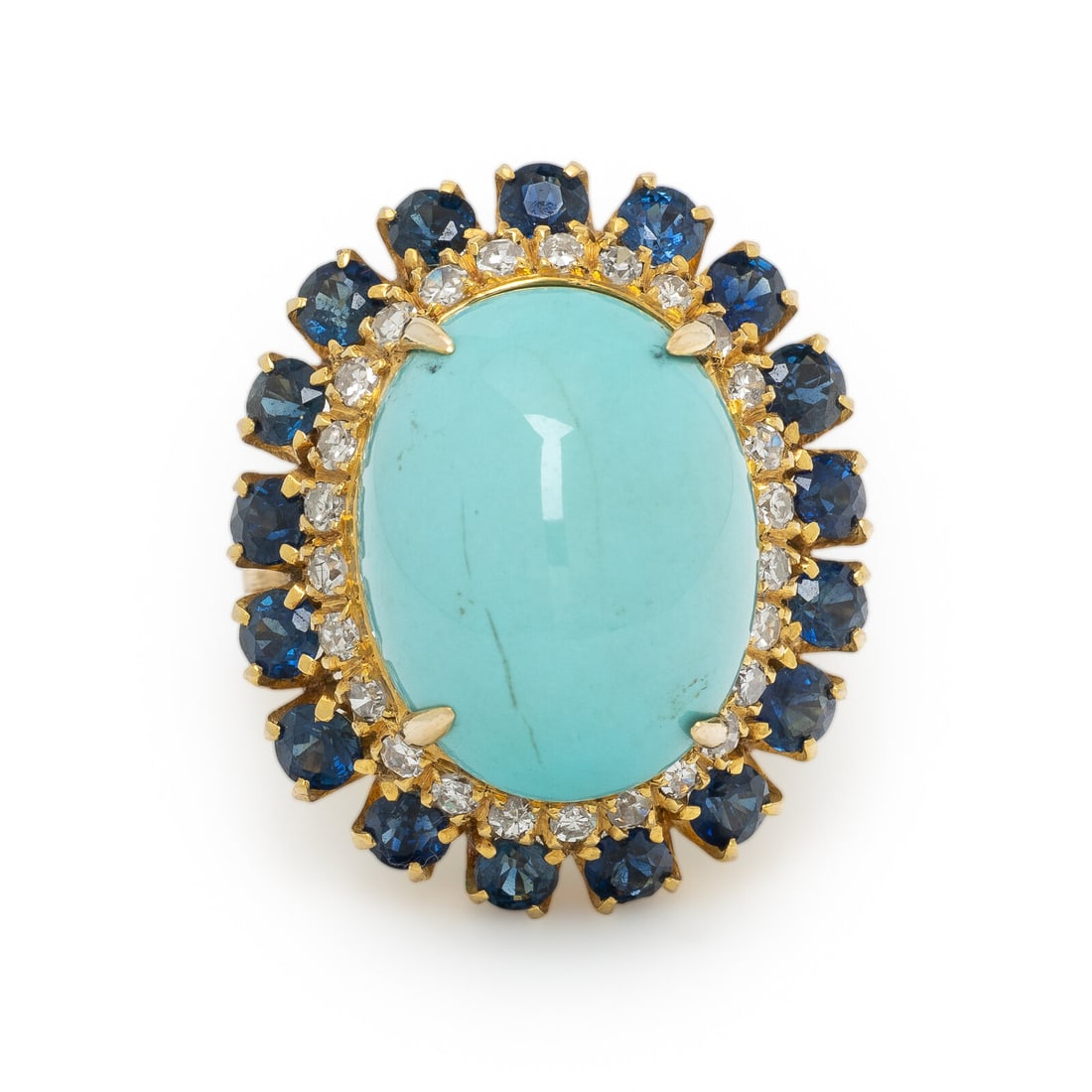 TURQUOISE, SAPPHIRE, DIAMOND, AND YELLOW GOLD RING: TURQUOISE, SAPPHIRE, DIAMOND, AND YELLOW GOLD RING In a radial design, centered by an oval cabochon turquoise measuring approximately 17.35 x 13.75 mm, surrounded by round diamonds and round sapphires