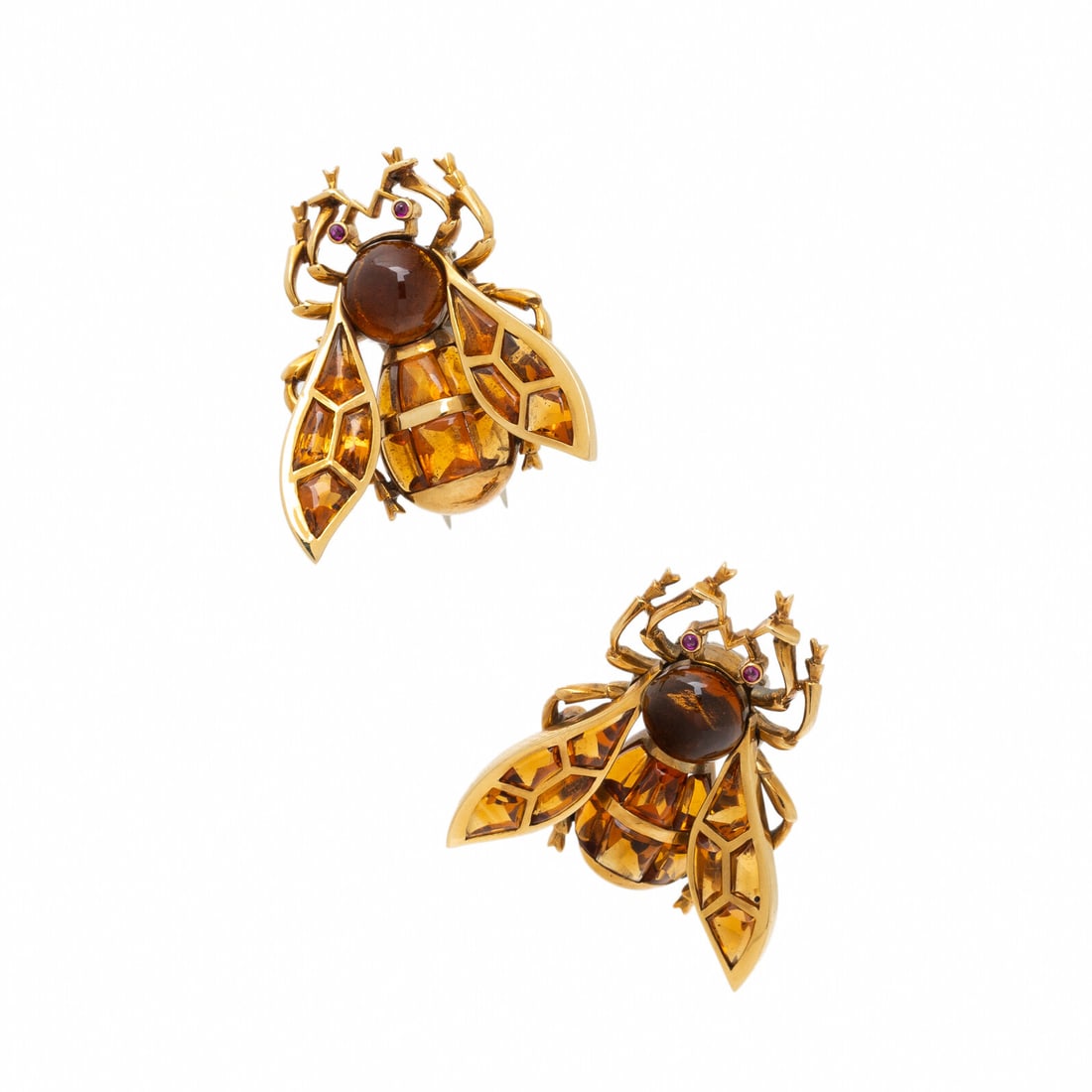 TWO CITRINE AND YELLOW GOLD BEE BROOCHES: TWO CITRINE AND YELLOW GOLD BEE BROOCHES A pair of brooches designed as bees, set with round and freeform cabochon citrines and round cabochon rubies. Mounted in yellow gold. Each 1 x 7/8 inches.