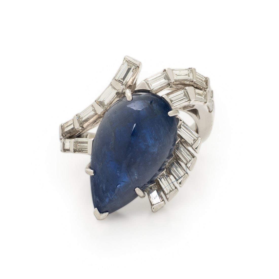 UNHEATED BURMESE SAPPHIRE AND DIAMOND RING: UNHEATED BURMESE SAPPHIRE AND DIAMOND RING Featuring a pear shape cabochon unheated Burmese sapphire weighing approximately 10.00 - 11.00 carats by formula, accented with baguette cut diamonds