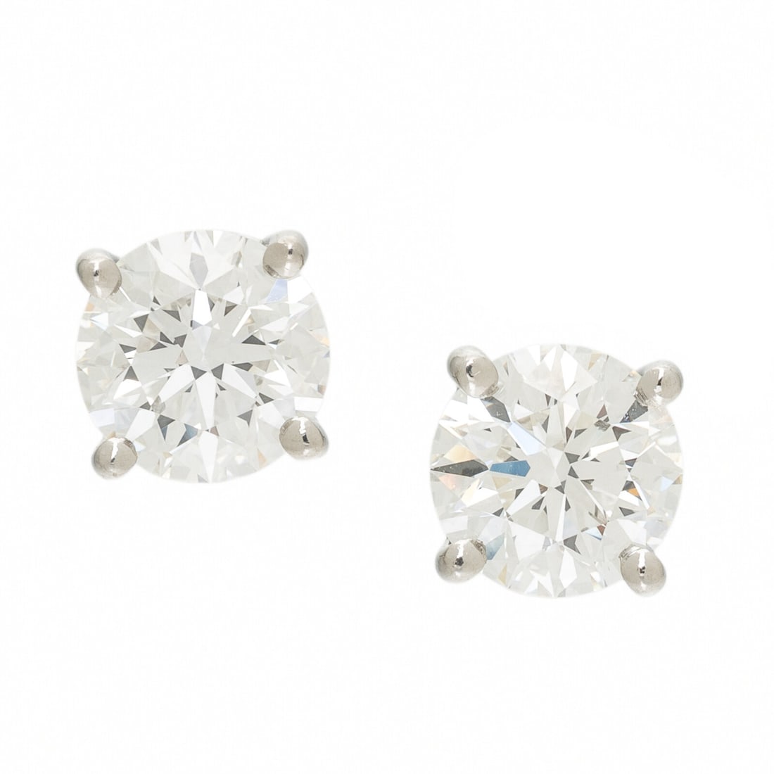 TIFFANY & CO., DIAMOND AND PLATINUM STUD EARRINGS: TIFFANY & CO., DIAMOND AND PLATINUM STUD EARRINGS Featuring two round diamonds weighing x carats and x carats respectively. Mounted in platinum. 1/4 inch long. Stamp: T&CO. PT950 27996213.
