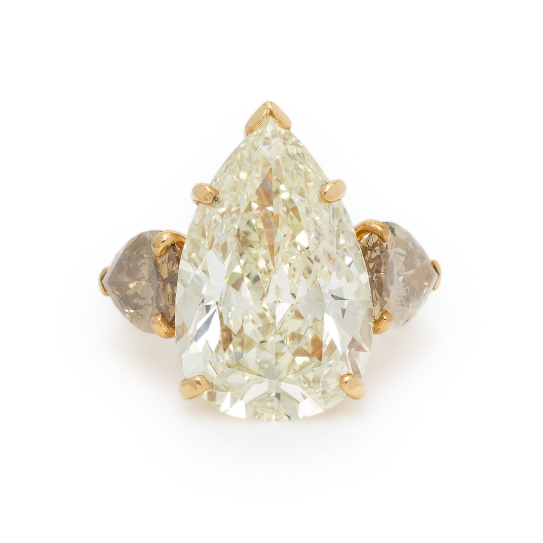 COLORED DIAMOND AND YELLOW GOLD RING: COLORED DIAMOND AND YELLOW GOLD RING Featuring a pear brilliant cut diamond weighing 13.18 carats, flanked by two pear shaped Fancy brown diamonds (origin of color not tested) weighing approximately