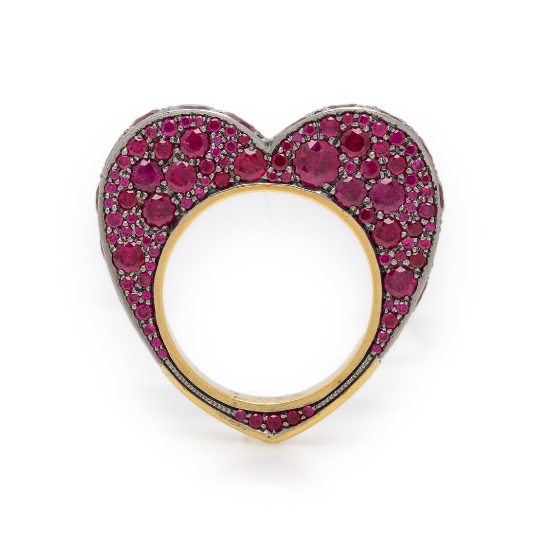 JESSICA MCCORMACK, RUBY AND BICOLOR GOLD HEART RING: JESSICA MCCORMACK, RUBY AND BICOLOR GOLD HEART RING The profile designed as a heart, pavé set with rubies. Mounted in yellow and blackened gold. Ring size 7 1/4. Gross weight: 12.05 dwt. This