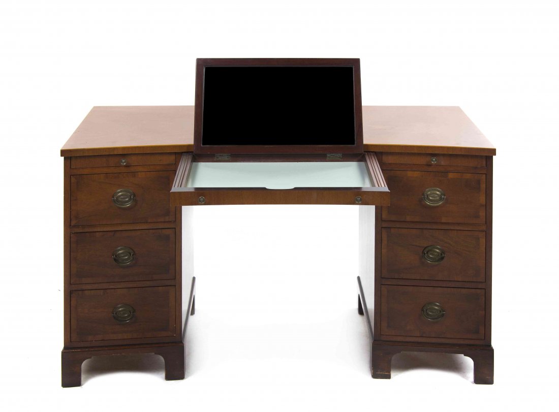 An Edwardian Style Mahogany Pedestal Desk, Height 29 3/: An Edwardian Style Mahogany Pedestal Desk, the rectangular top with a concave front over the conforming case, fitted with a pullout slide, having an adjustable mirror, raised on twin pedestals, each s