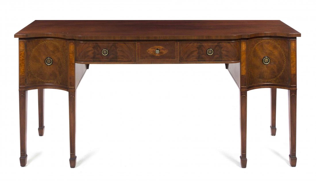 A Federal Style Mahogany Sideboard, Height 35 1/2 x wid: A Federal Style Mahogany Sideboard, having a serpentine front over three drawers and two concave paneled doors, raised on square tapering legs ending in spade feet. Height 35 1/2 x width 76 x depth 22