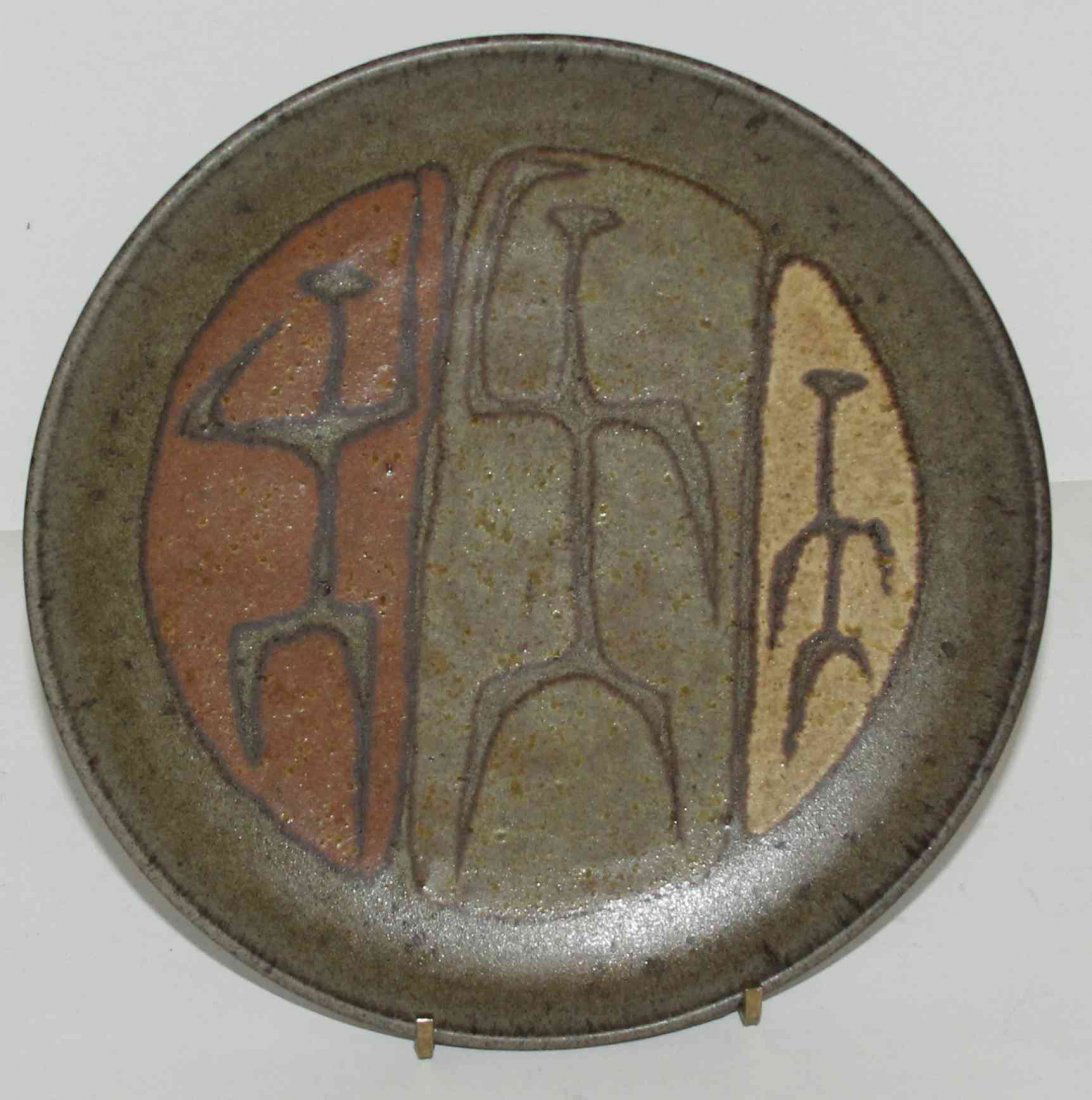 An American Studio Ceramic Plate, Clyde Burt (1922-1981: An American Studio Ceramic Plate, Clyde Burt (1922-1981), of circular form with three-color glaze and three stylized figures. Diameter 7 1/2 inches.