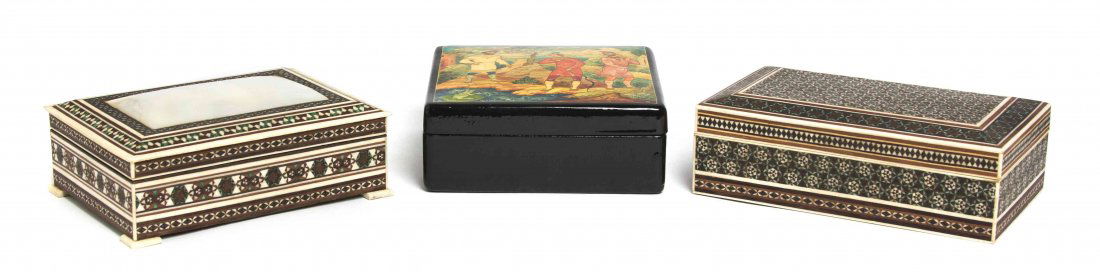 A Collection of Three Decorative Boxes, Width of widest: A Collection of Three Decorative Boxes, comprising a Russian lacquered example and two ivory examples, one with a mother-of-pearl panel. Width of widest 6 1/8 inches. Property from the Estate of Mr. E