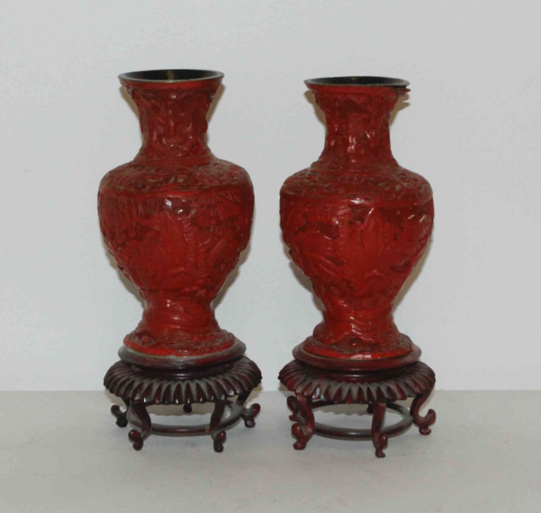 A Pair of Cinnabar Lacquered Vases, Height 6 1/4 inches: A Pair of Cinnabar Lacquered Vases, of baluster form, each decorated with continuous bands of figures and landscapes, set on fitted hardwood stands. Height 6 1/4 inches.