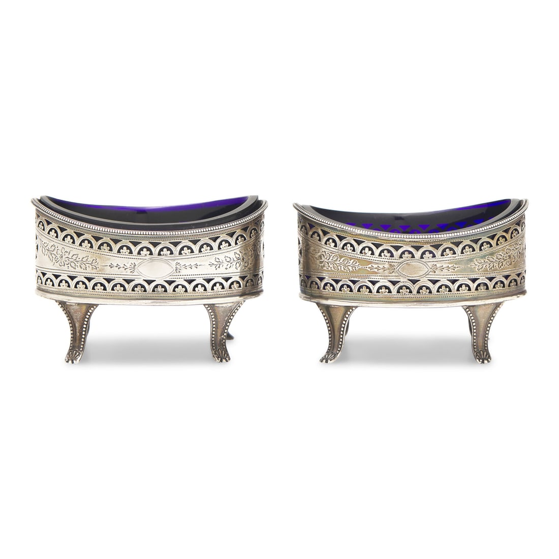 A Pair of George III Engraved and Pierced Silver Lozenge-Form Salt Cellars: A Pair of George III Engraved and Pierced Silver Lozenge-Form Salt Cellars Peter and Jonathan Bateman, London, 1790 engraved with floral motifs, each fitted with a wheel-cut cobalt glass liner. hallma