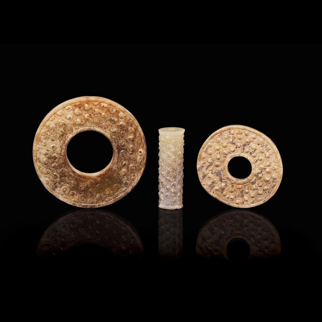 An assembled set of two small Chinese jade bi discs and a jade tube, Warring State period 戰 (1 of 5)