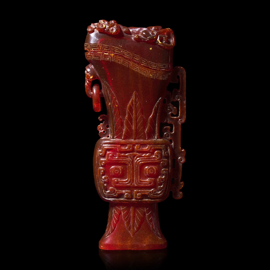 A Chinese Carved Amber Archaistic Gong Vase and Cover, Late Qing Dynasty 清晚期: A Chinese Carved Amber Archaistic Gong Vase and Cover, Late Qing Dynasty 清晚期 琥珀仿古觥 19th/Early 20th Century The vase decorated with taotie masks