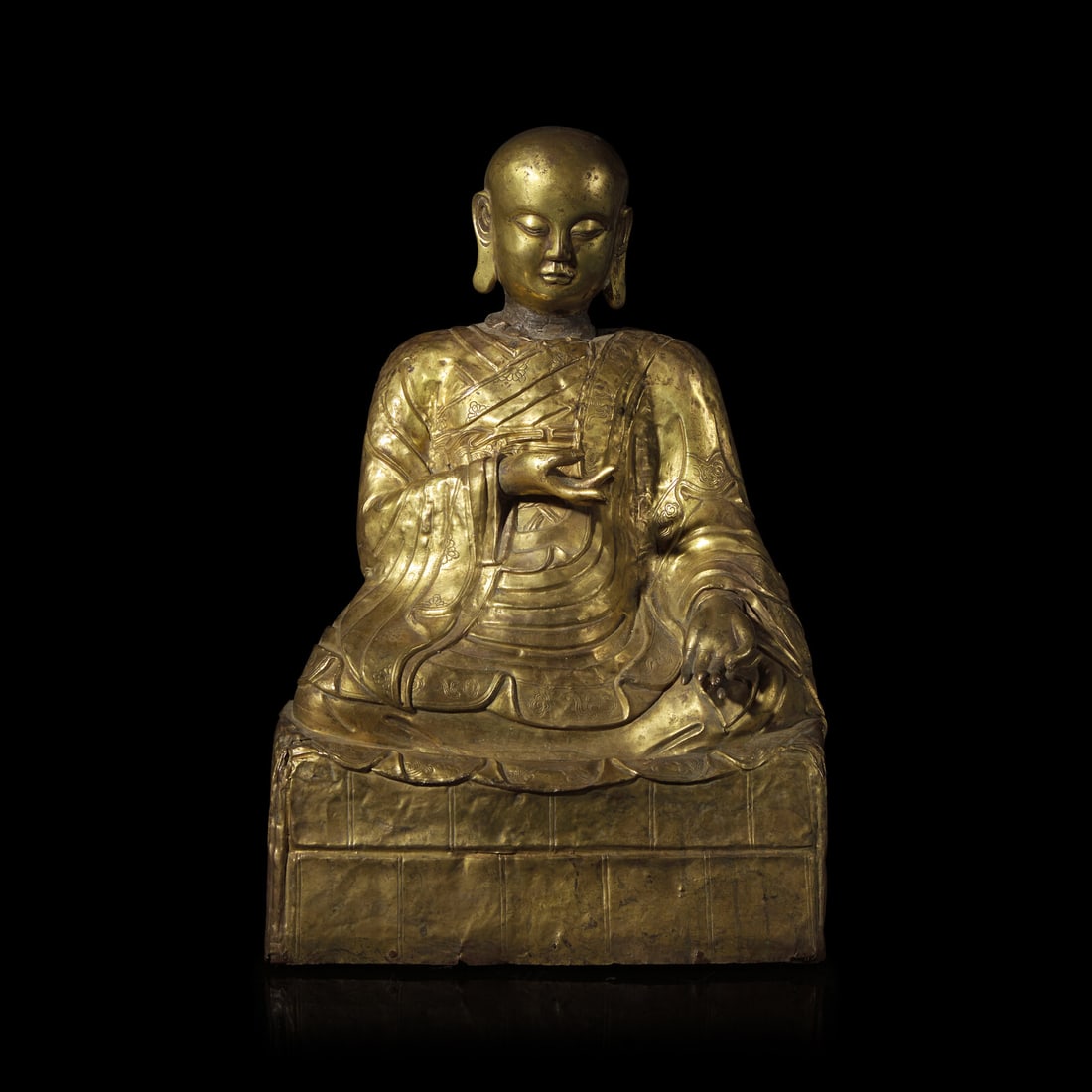 A Mongolian Gilt Copper Repoussé Figure of a Seated Luohan or Monk, 19th Century 清: A Mongolian Gilt Copper Repoussé Figure of a Seated Luohan or Monk, 19th Century 清晚期 蒙古銅錘揲羅漢像 19th Century Depicted se