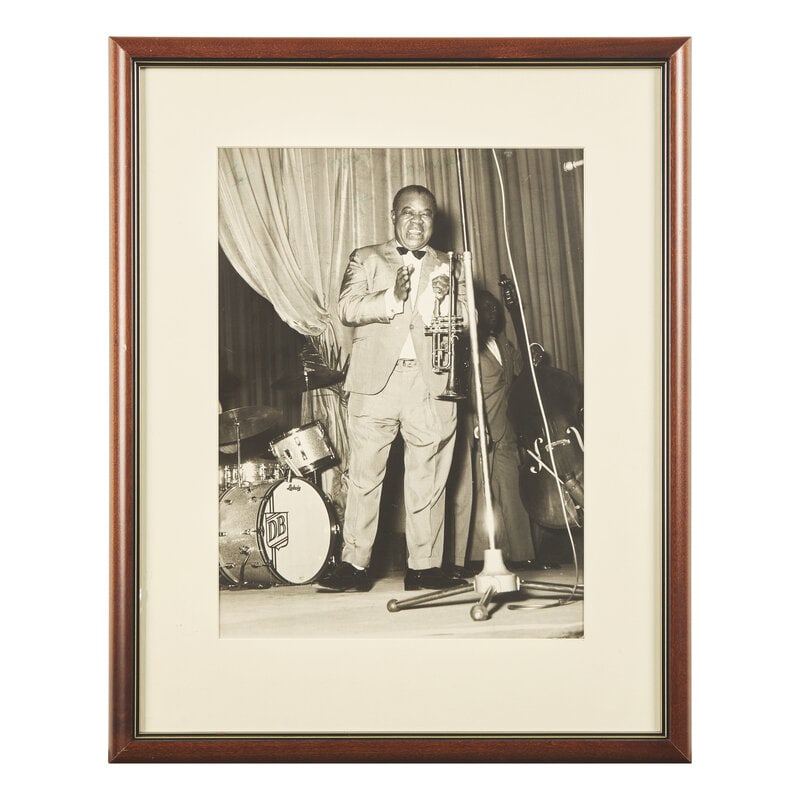 [African Americana] Armstrong, Louis. Inscribed Photograph: [African Americana] Armstrong, Louis. Inscribed Photograph No place, no date. Large black and white photograph of jazz legend Louis Armstrong, 14 3/4 x 10 3/4 in. (sight) (375 x 273 mm). Inscribed