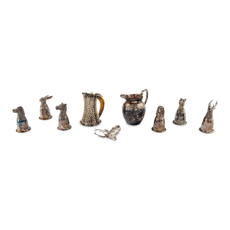 A Group of Nine Silverplate Articles: A Group of Nine Silverplate Articles 19th/20th Century includes six animal form stirrup cups, a stag form wine stopper, a hammered pitcher and a boars tusk handles tankard. Largest height 7 1/2