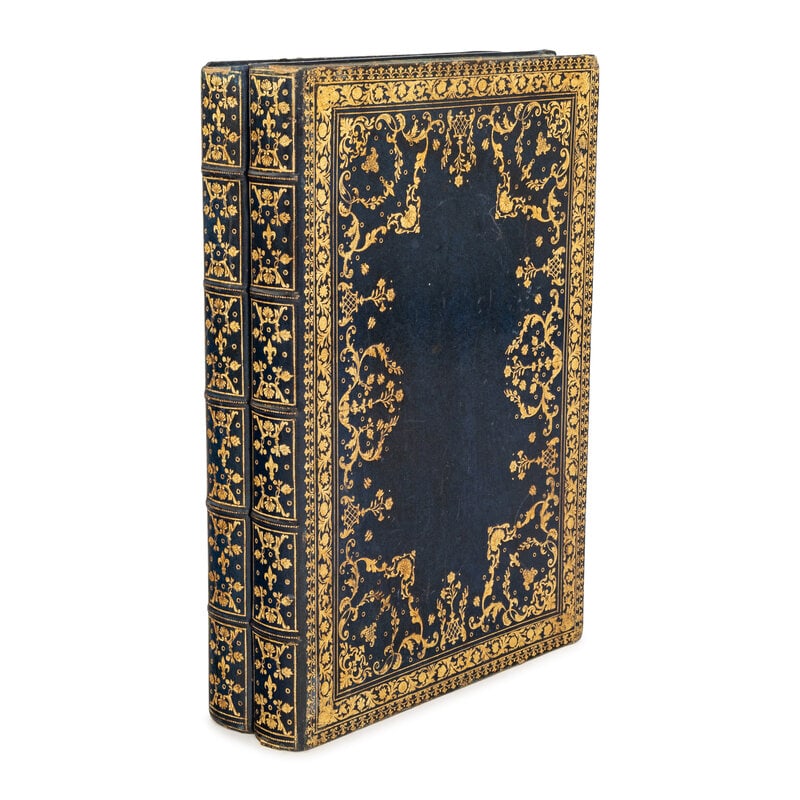 A Gilt-Tooled Leather Backgammon Board: A Gilt-Tooled Leather Backgammon Board 20th century in the form of a book, inscribed CARTIER NEW YORK-PARIS-LONDON / MADE IN FRANCE. width closed 15in (38cm) Property of a California Collector This