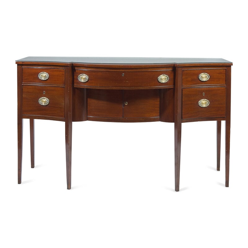 A Federal Style Serpentine Mahogany Sideboard: A Federal Style Serpentine Mahogany Sideboard Late 19th / Early 20th Century with long drawer flanked by two short drawers, over doors revealing storage compartment, flanked by two deep drawers,