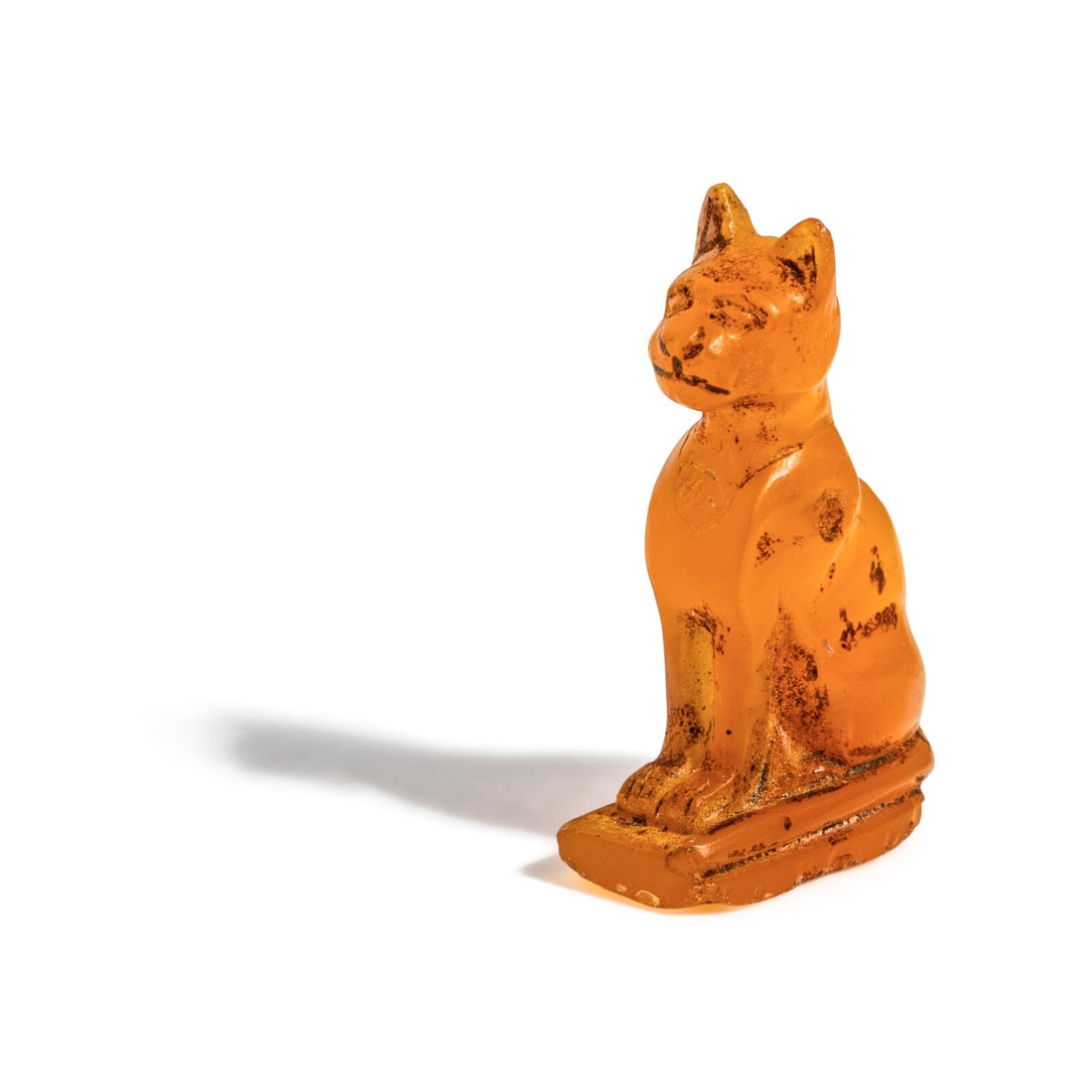 An Egyptian Carnelian Cat: An Egyptian Carnelian Cat New Kingdom, Circa 1550–1070 B.C. Height 2.2 cm (7/8 inch). Property from a New England Collection Provenance: Carl Tautenhahn (1924-2008), Houston. For a comparable